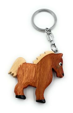 a wooden keychain with a horse on it's front and back ends