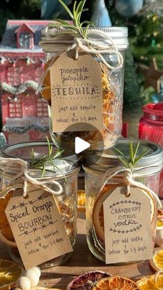 jars filled with oranges and spices on top of a table