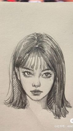 a pencil drawing of a woman's face with long hair and bangs on paper