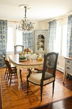 a dining room table with chairs and a chandelier