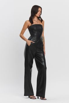 Starlit Muse Jumpsuit featuring a strapless fitted top, zipper pockets, and wide-legged pants in black faux leather. Formal Fitted Strapless Jumpsuit, Fitted Strapless Jumpsuit For Date Night, Fitted Strapless Bandeau Jumpsuit For Date Night, Fitted Bandeau Strapless Jumpsuit For Date Night, Chic Strapless Jumpsuit For Night Out, Strapless Fitted Jumpsuit For Night Out, Fitted Strapless Jumpsuit For Night Out, Solid Color Strapless Wide Leg Jumpsuit For Party, Strapless Pantsuit For Night Out