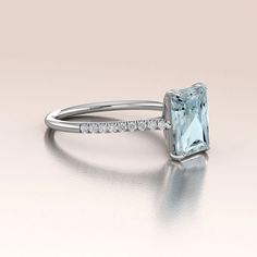 This is our new Aquamarine Ring (this video is showing same style ring but in Rose Gold with Morganite) made in 14K White Gold. The center stone is about 2.5ct (9x7mm) beautiful Aquamarine (color may vary due to the nature of the stone) set in a four prong solitaire setting. There are genuine White Diamonds along the cathedral style shank set micro pave raising elegantly towards the center stone with total weight about 0.15ct. (G-H, SI-1). This ring can be perfect for an alternative engagement r Aquamarine Emerald Cut Engagement Ring, Formal Aquamarine Ring With Emerald Cut, Modern Bride Jewelry, White Gold Aquamarine Rings With Brilliant Cut, Emerald-cut White Gold Aquamarine Ring, Blue Aquamarine Emerald-cut Diamond Ring, Aquamarine Wedding Ring, Aquamarine Colour, Aquamarine Engagement Ring