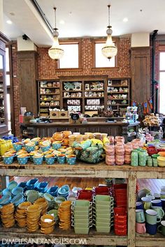 there are many plates and bowls on display in the store's shop window sill