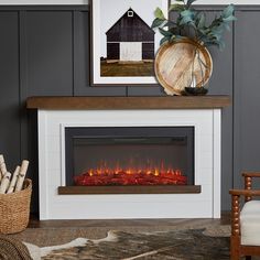 a white fireplace with an electric fire in it