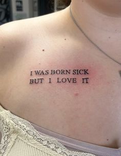 a woman with a tattoo on her chest saying i was born sick but i love it