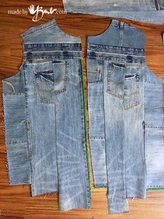 three pieces of denim sitting next to each other on a wooden floor with one piece cut out