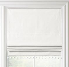 an open window with white roman blind