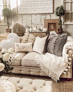 a living room filled with lots of furniture and pillows