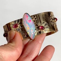 "14K WIDE Opal Cuff Bracelet, Botanical Solid Gold Bracelet, Hand Forged 14K Yellow Gold Artwork Cuff, Emerald Cuff, Rubellite Tourmaline From any and every angle this baby is a LUXURY DREAM come true🌈As I was working on this piece I fondly began to refer to it as \"The opal garden\"...so that shall be her name! 🌺 The center stone is a 9.1 carat Brazilian opal with 5/5 complete rainbow fire at every angle. I cannot even capture half of it in photos - this is a \"must see in person to believe i Luxury Gold Artisan Cuff Bracelet, Adjustable Gold-tone Cuff Bracelet Gold Plated, Adjustable Yellow Gold-plated Cuff Bracelet, Opal Cuff Bracelet, Luxury Gold Multi-stone Cuff Bracelet, Flower Cuff Bracelet, Bracelet Emerald, Gold Artwork, Rainbow Fire