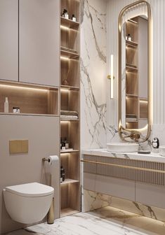 a white toilet sitting next to a sink in a bathroom under a large golden mirror