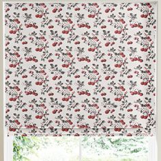 the roman blind with cherries and leaves on it is in front of a window