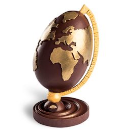 an egg shaped like the world on top of a stand with a gold and brown globe