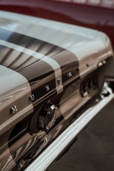 the side view of a red car with chrome lettering