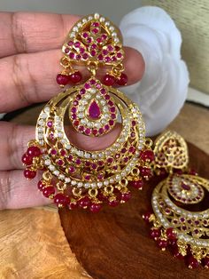 Hyderabadi Jadau Pearls Red Stone Chandbali EarringsColor : GoldenSize : Earring Length : 3 Inches; Weight : 17 Grams Each;Stones : Red Stone Pearls