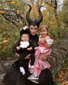 two children and an adult are dressed up as maleficent