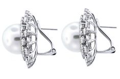 These stunning white south sea pearl diamond-accented omega earrings are a very versatile design. These white earrings are made up of an 18k white gold that gleams beautifully in the light and is set with high-quality diamonds and a white 14mm pearl. Every well-stocked jewelry collection should have a pair of pretty pearl earrings in them. They are formal enough to wear at night for a hot date, or even as bridal jewelry for your big day. We have a feeling that once you add these stud earrings to Anniversary White Diamond Clip-on Earrings, White Round Clip-on Diamond Earrings, White Clip-on Pearl Earrings Fine Jewelry, Sea Pearl, Sea Pearls, South Sea Pearls, South Seas, Pearl Diamond, White Earrings