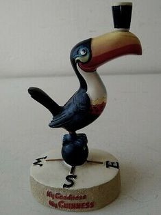 a figurine of a bird with a top hat on it's head