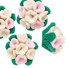 three pieces of green, white and pink flower broochies on a white background