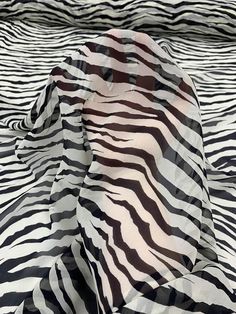 an animal print fabric with black and white stripes on it's surface, as if in the wild