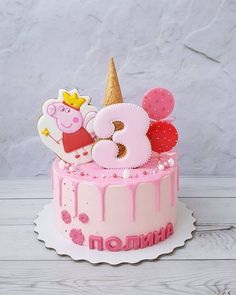 a pink birthday cake with pep the pig on top