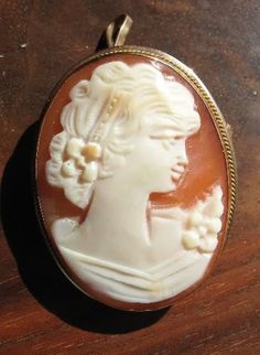 "Original Victorian cameo, circa 1860's, 18K Yellow Gold, Great Value, signed \"750\" in a diamond, Brooch and pendant Genuine shell cameo, face is carved by hand. Excellent condition. Measures: 1 1/16 x 3/4 inches." Victorian Oval Jewelry For Opera, Victorian Cameo Jewelry For Anniversary, Antique Cameo Brooches For Wedding, Heirloom Cameo Brooch For Wedding, Heirloom Cameo Wedding Brooch, Heirloom Cameo Brooches For Weddings, Victorian Style Cameo Brooch For Weddings, Victorian Cameo Brooch For Wedding, Victorian Cameo Jewelry