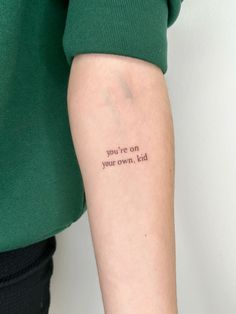 a woman's arm with a tattoo saying you're on your own, kill