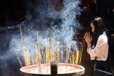 size: 12x8in Photographic Print: Buddhist worshipper burning incense sticks, Chua On Lang Taoist Temple by Godong :