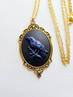 JUST LISTED Blue Iridescent Raven Crow Gothic Rockabilly Cameo Gold Necklace Pendant Victorian Jewelry Hand painted cameo If you are wanting a specific color please feel free to contact me and I will do my best to create what you are searching for. Victorian Jewelry substantial in size at just a little over 2 INCHES Long Center is 40mmx30mm **MATCHING ITEMS IN OUR STORE BADGE HOLDER BROOCH HAIR PINS - CLIPS** **thank you for taking the time to look at our items. Each item is handcrafted and atte Gothic Rockabilly, Rockabilly Earrings, Antique Gold Necklace, Gold Necklace Pendant, Christmas Gifts For Sister, Bronze Necklace, Jewelry Hand, Cameo Necklace, Victorian Jewelry