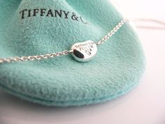 Overview: Offered for sale is a wonderful and rare Tiffany classic. Whether you are just starting your Tiffany collection or are thinking of adding another piece, this one is perfect for you. Tiffany & Co. Elsa Peretti’s 3 Bean necklace is a Tiffany classic that will never go out of style. It will most certainly be a piece that you will turn to over and over again, so it is great value for your money! It is a wonderful necklace that fits a lifestyle on the go -- it can be worn to almost any Bean Necklace, Speakeasy Party, Elsa Peretti, Blue Box, Tiffany And Co, Tiffany Blue, Jewelry Inspo, Go Out, Out Of Style