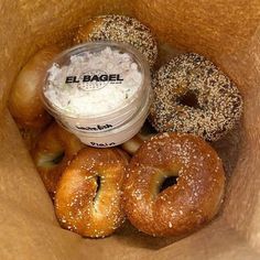 an open bagel box filled with doughnuts and cream