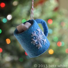 a tea pot ornament hanging from a christmas tree