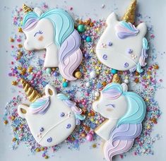 decorated cookies in the shape of unicorns with sprinkles