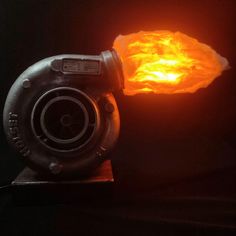 a blow dryer sitting on top of a wooden table next to a glowing object