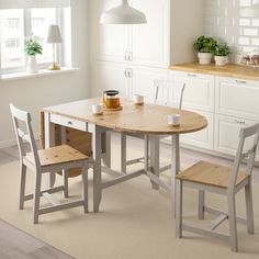 a kitchen table with two chairs around it