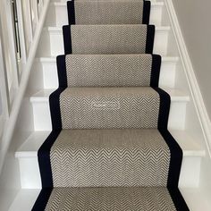 a set of stairs with black and white carpet