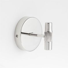 a chrome wall mounted toilet paper dispenser