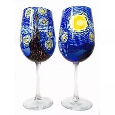 two wine glasses with designs painted on them