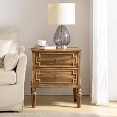 a living room scene with focus on the end table and coffee cup sitting on it