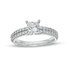 a white gold engagement ring with diamonds on the band and a princess cut center stone