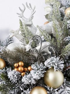 a christmas tree with gold and silver ornaments