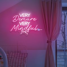 a pink neon sign that says very demune very mindful