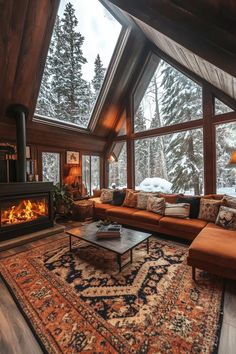 a living room filled with furniture and a fire place in the middle of a floor to ceiling window