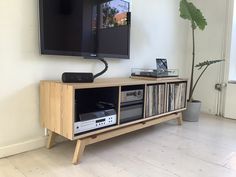 a television is mounted on the wall next to a record player