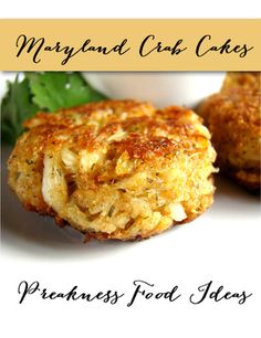 two crab cakes on a white plate with parsley next to the top and another dish in the background