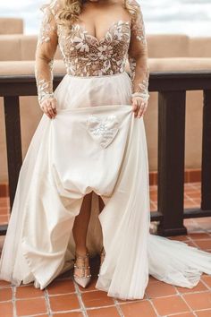 a woman in a white dress standing on a balcony with her legs crossed and wearing high heels