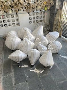 many white paper lanterns are on the ground