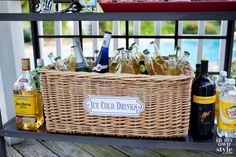 a wicker basket filled with alcohol bottles