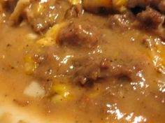 a close up of food on a plate with gravy