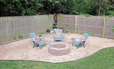 an outdoor fire pit surrounded by lawn chairs