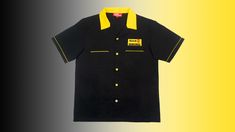 a black shirt with yellow trim on it